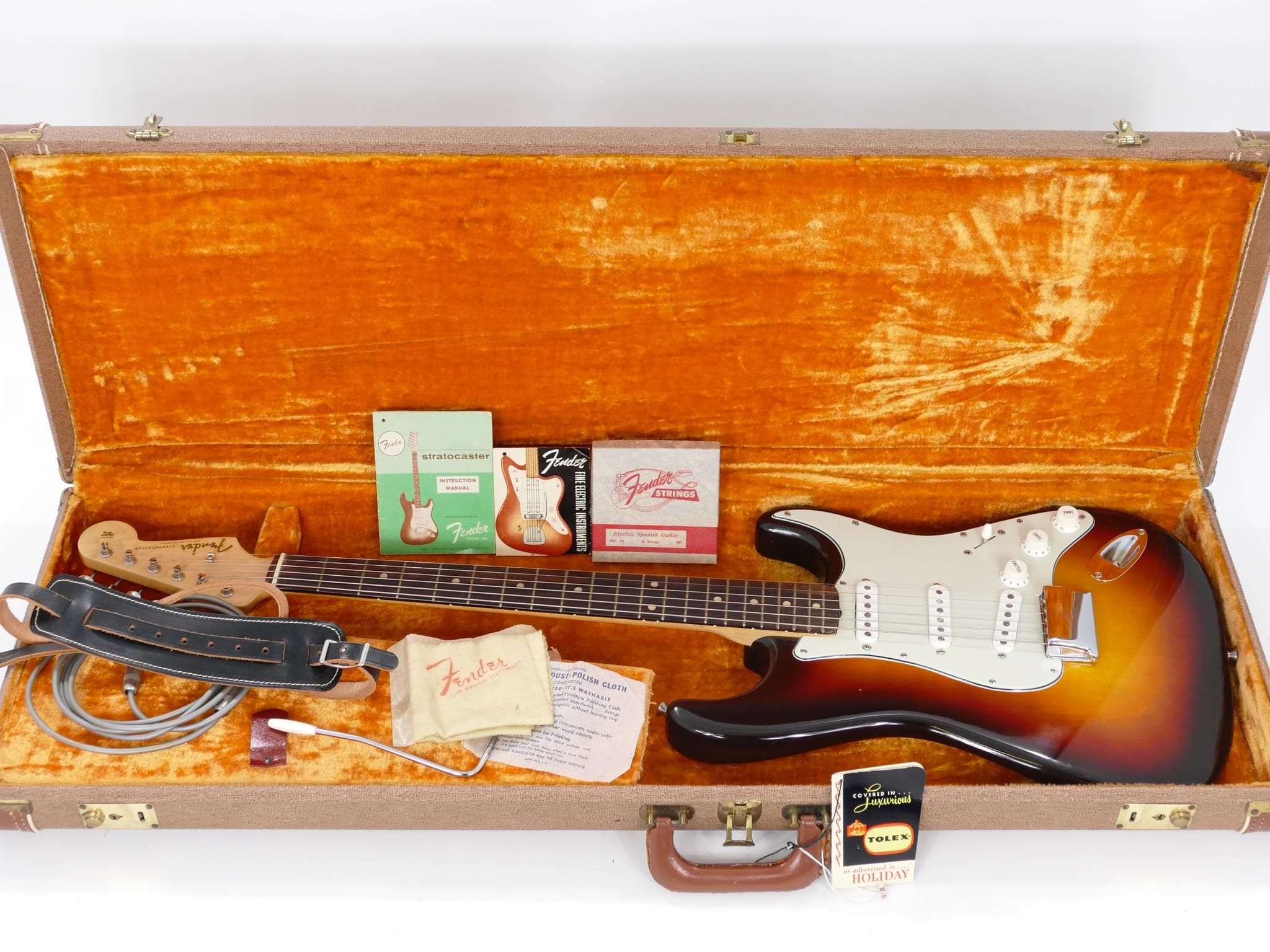 A close-up of a 1950s Fender Stratocaster style vintage guitar